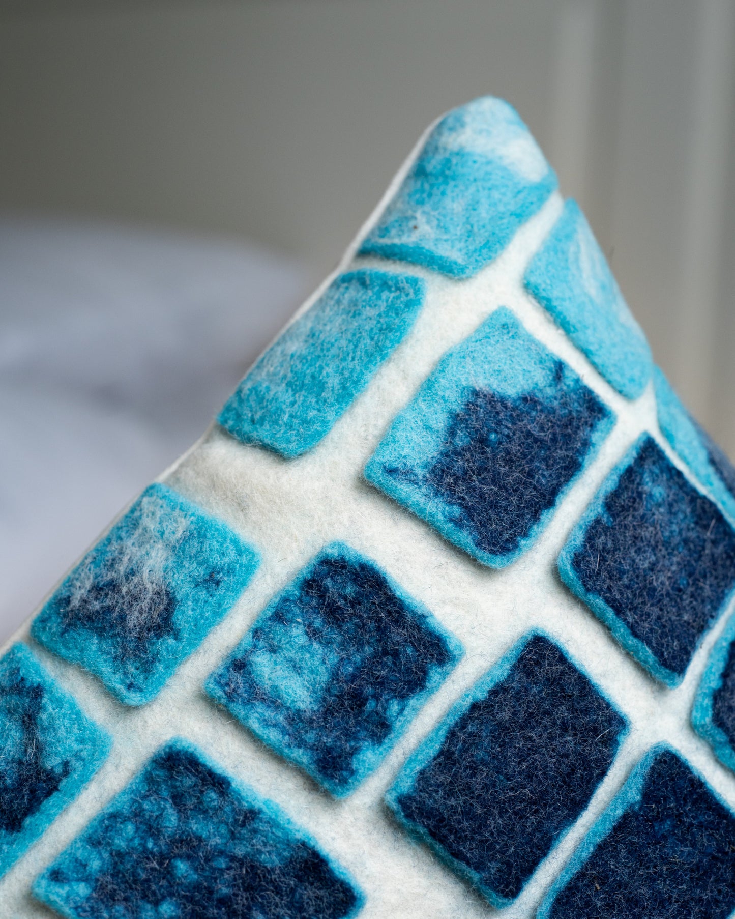 Handmade felted wool cushion with blue grid design – The Tuftista art pillow