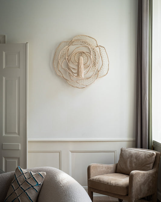 Circular wool wall sculpture with soft light and shadow play . The Tuftista