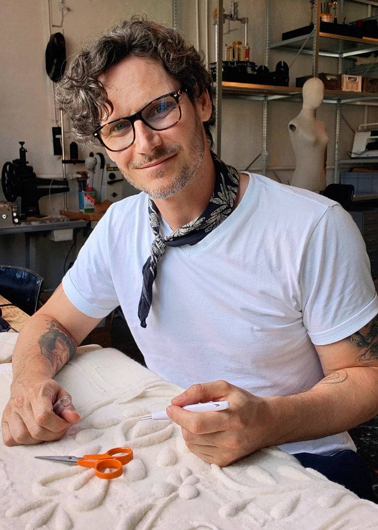 Oliver Pusztai artist of The Tuftista sitting in his studio in Copenhagen